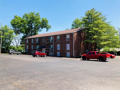 a large brick building with cars parked in front of it