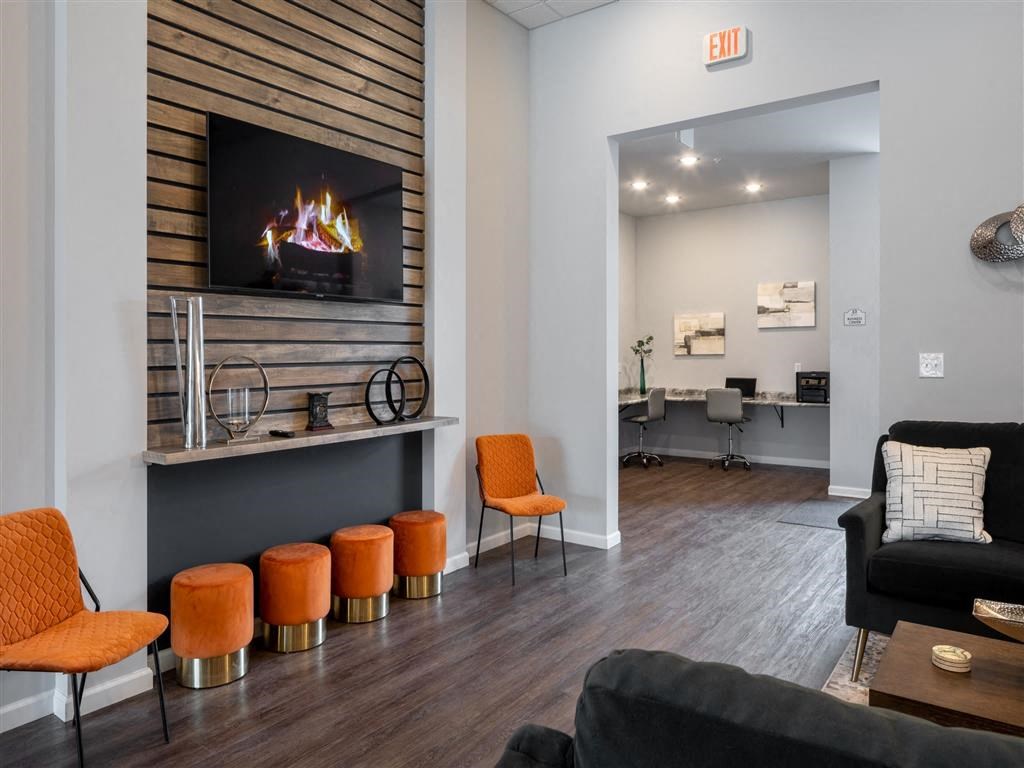 a living room with a fireplace and orange stools
