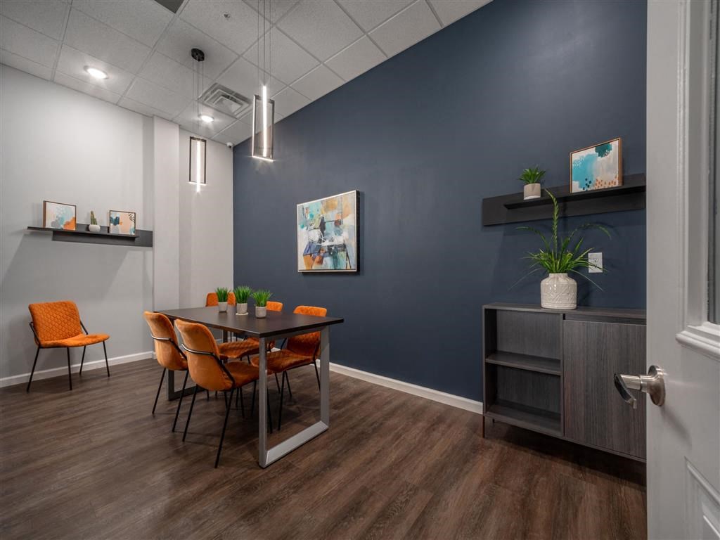 a dining room with a table and chairs