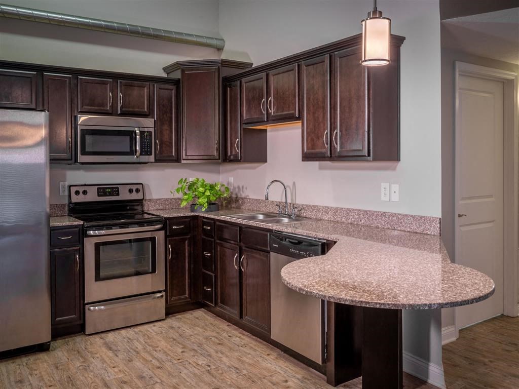 a kitchen with stainless steel appliances and granite counter tops