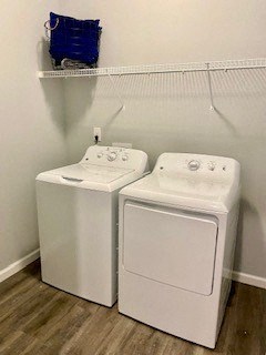two washers and dryers in a room with a white wall