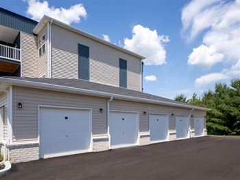 a row of white garage doors on the side of a building
