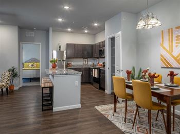 a kitchen and dining room with a table and chairs