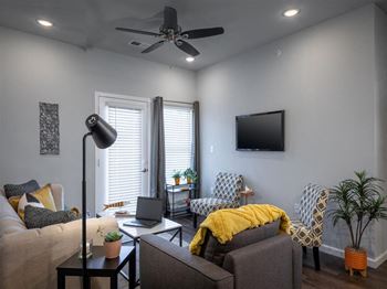 a living room with a couch and a ceiling fan