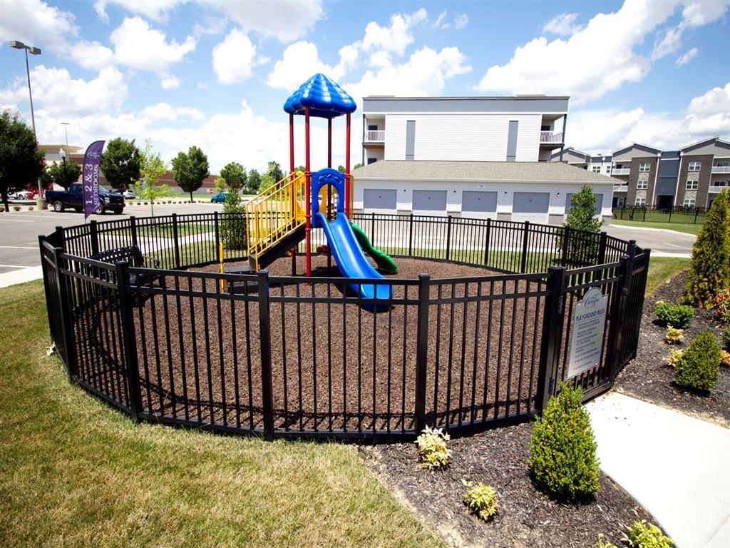 a playground in a yard with a slide
