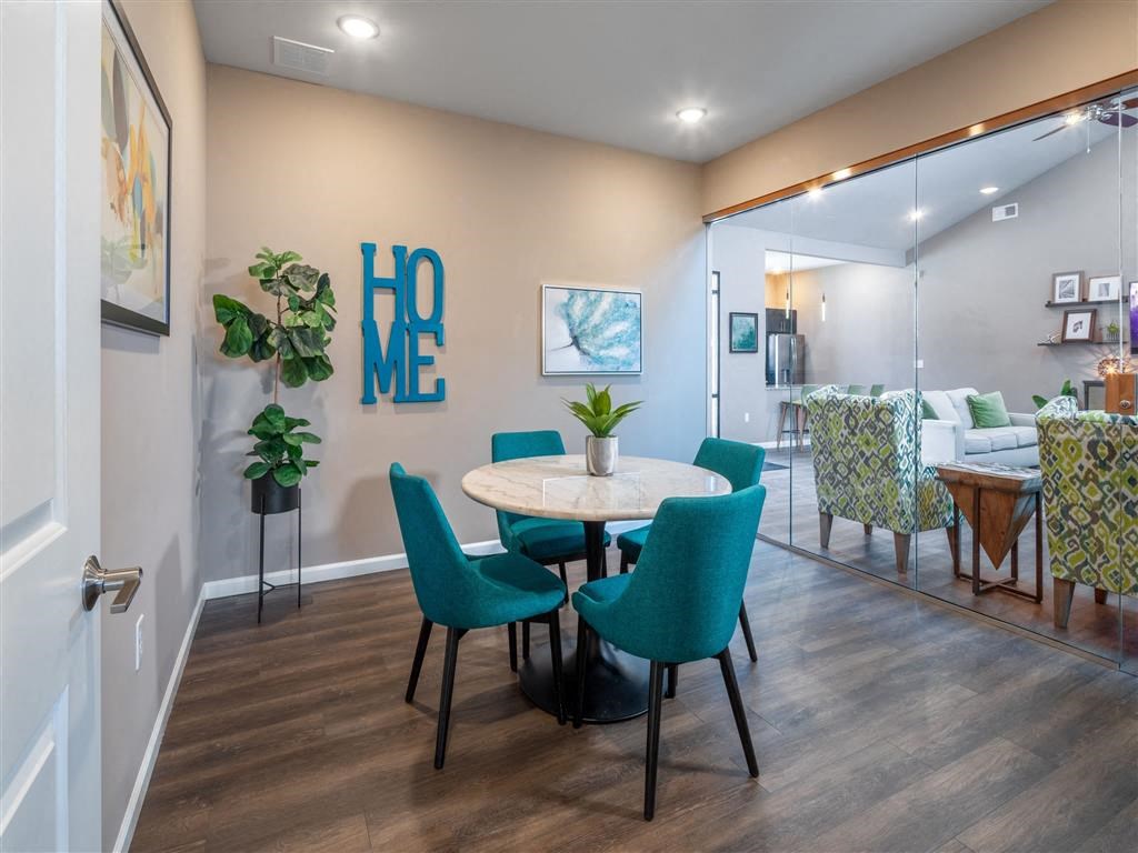 a dining room with a table and chairs