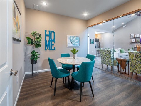 a dining room with a table and chairs