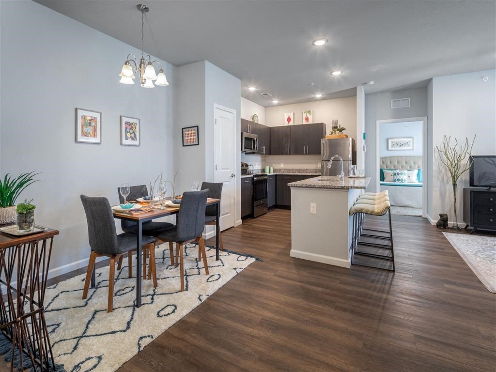 a dining room and kitchen with a table and chairs