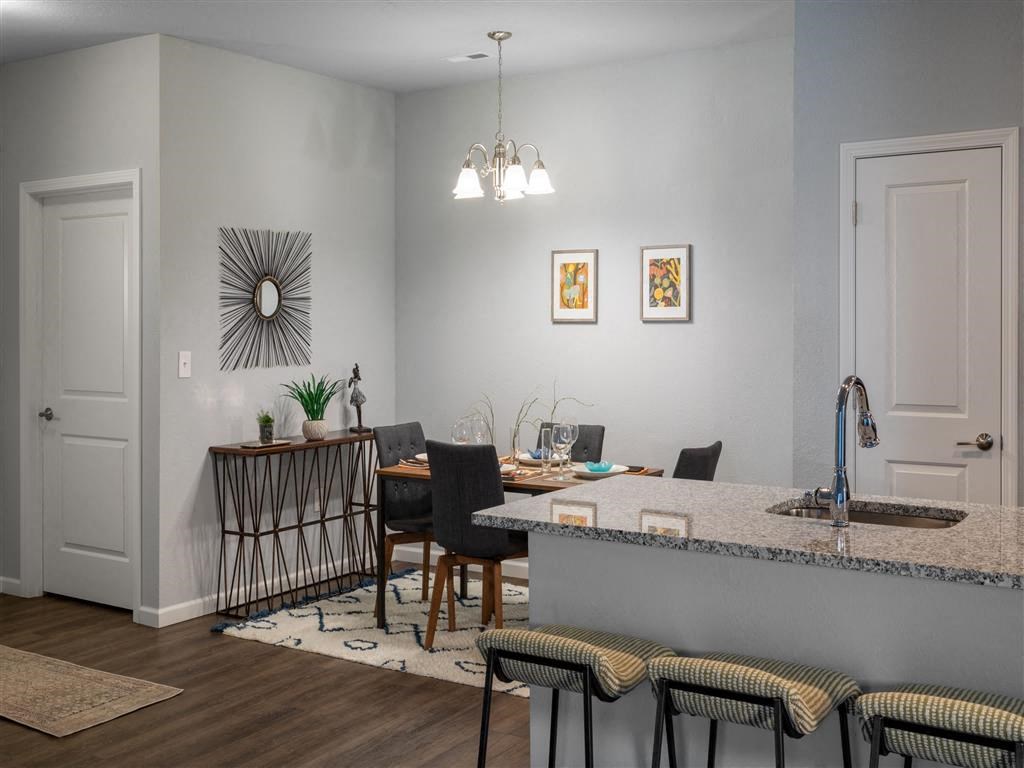 a kitchen and dining room with a table and chairs