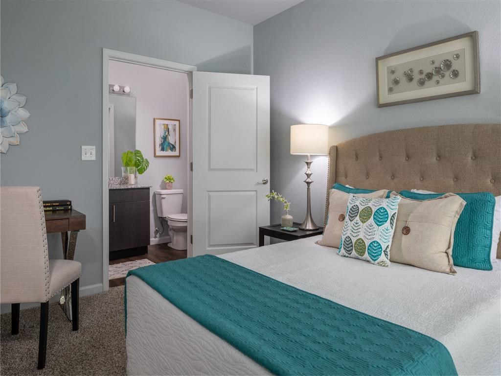 a bedroom with a bed and a bathroom