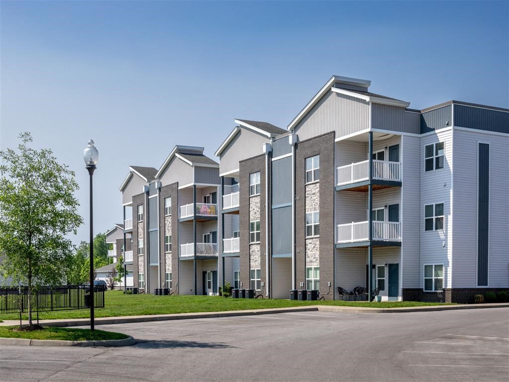 an empty parking lot in front of an apartment building