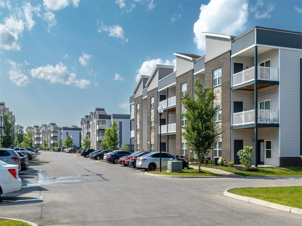 an empty parking lot in front of an apartment building