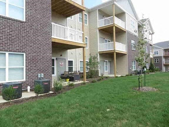 a man standing in front of an apartment building