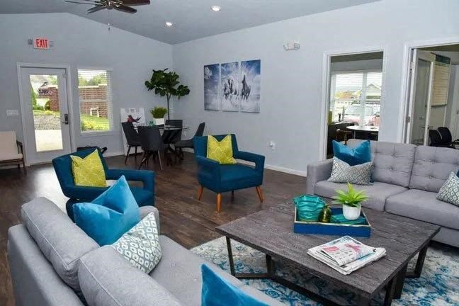 a living room with couches and chairs and a table