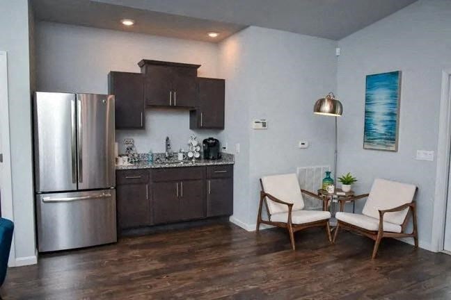 a kitchen with a stainless steel refrigerator and a table