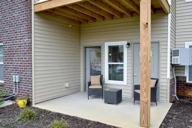 a porch with a chair and a table on it