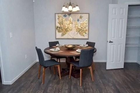 a dining room with a table and chairs