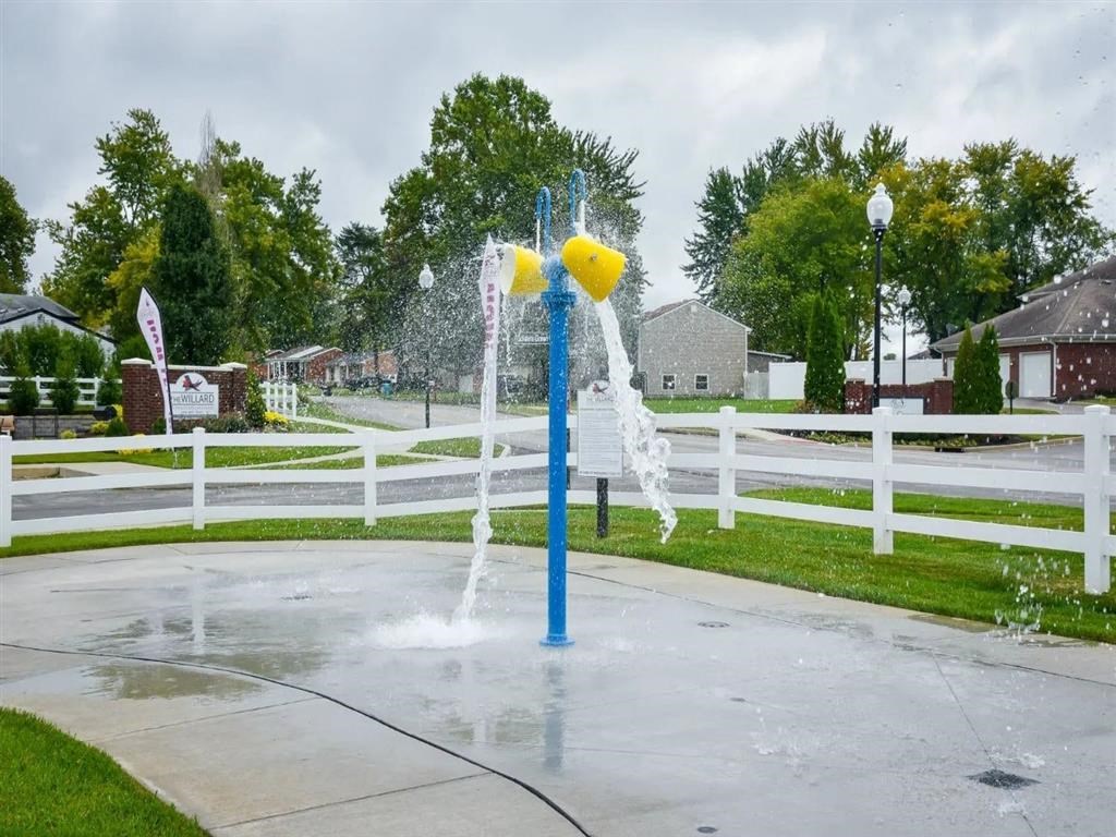 a blue and yellow water fountain in a park