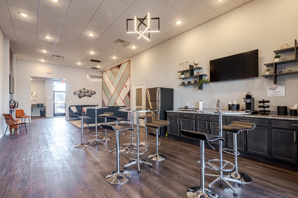 A bar area with a row of stools and a counter.