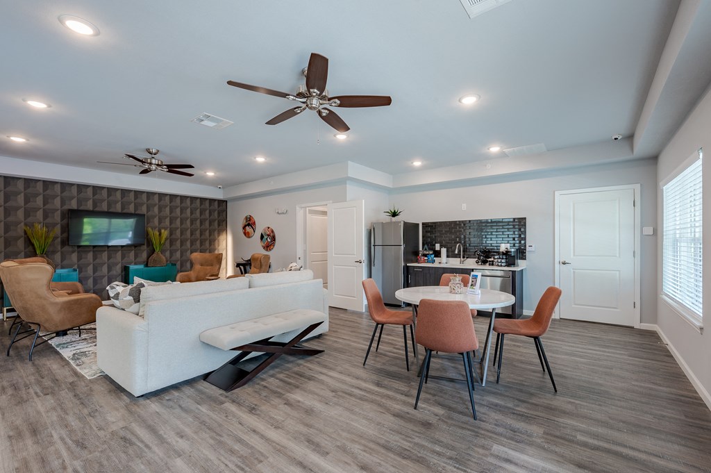 a living room with a white couch and a table with chairs