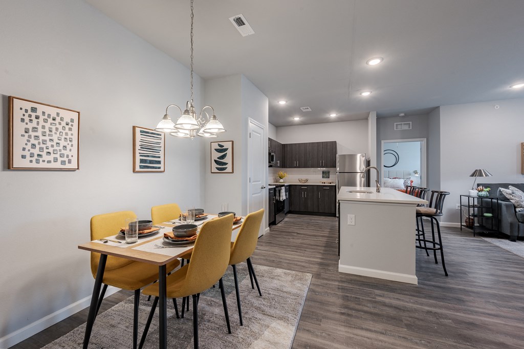 an open kitchen and dining room with a table and chairs