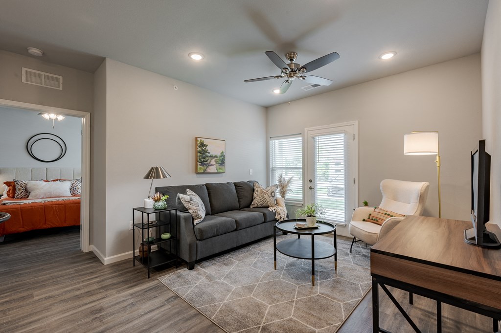 a living room with a couch and a ceiling fan