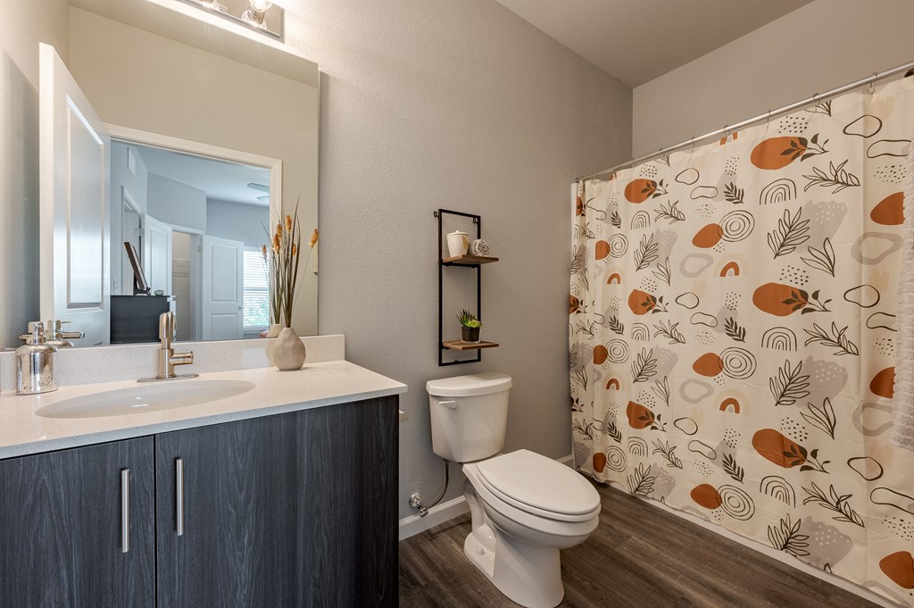 a bathroom with a shower and a sink and a toilet