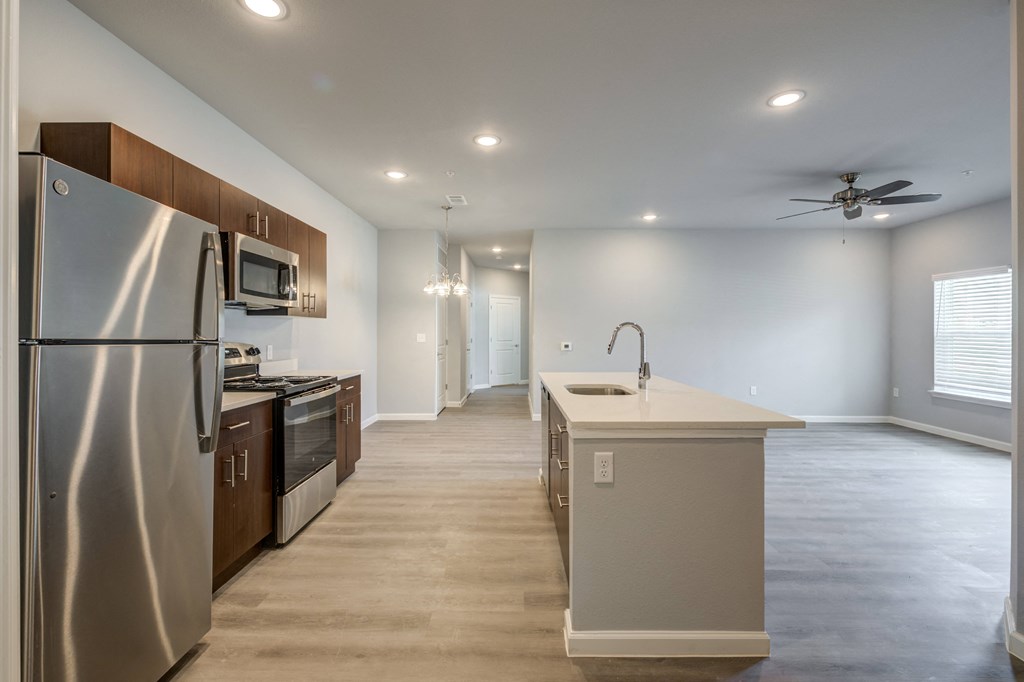 a kitchen with stainless steel appliances and a white counter top