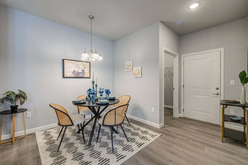 a dining room with a table and chairs and a door to a bathroom