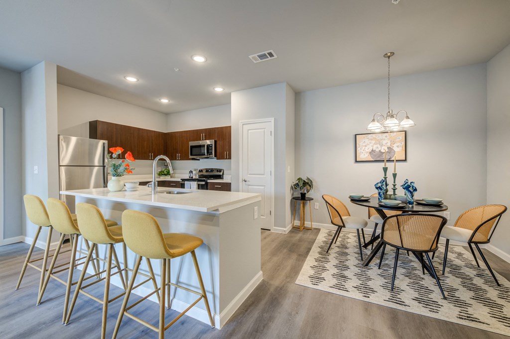 an open kitchen and dining area with a dining table and chairs
