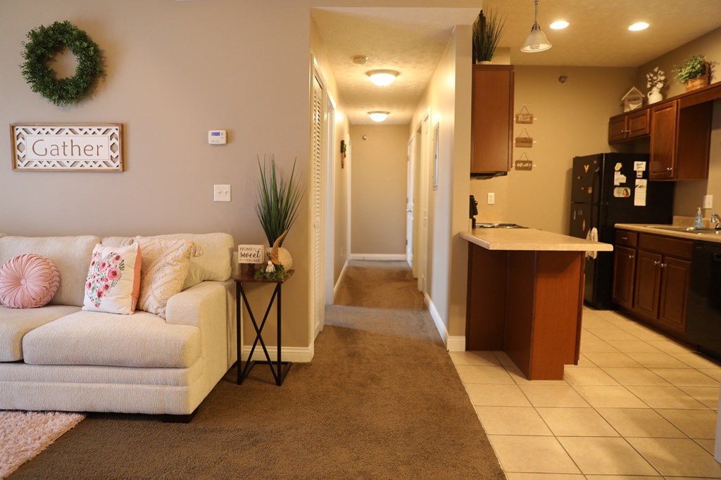 a living room with a couch and a kitchen