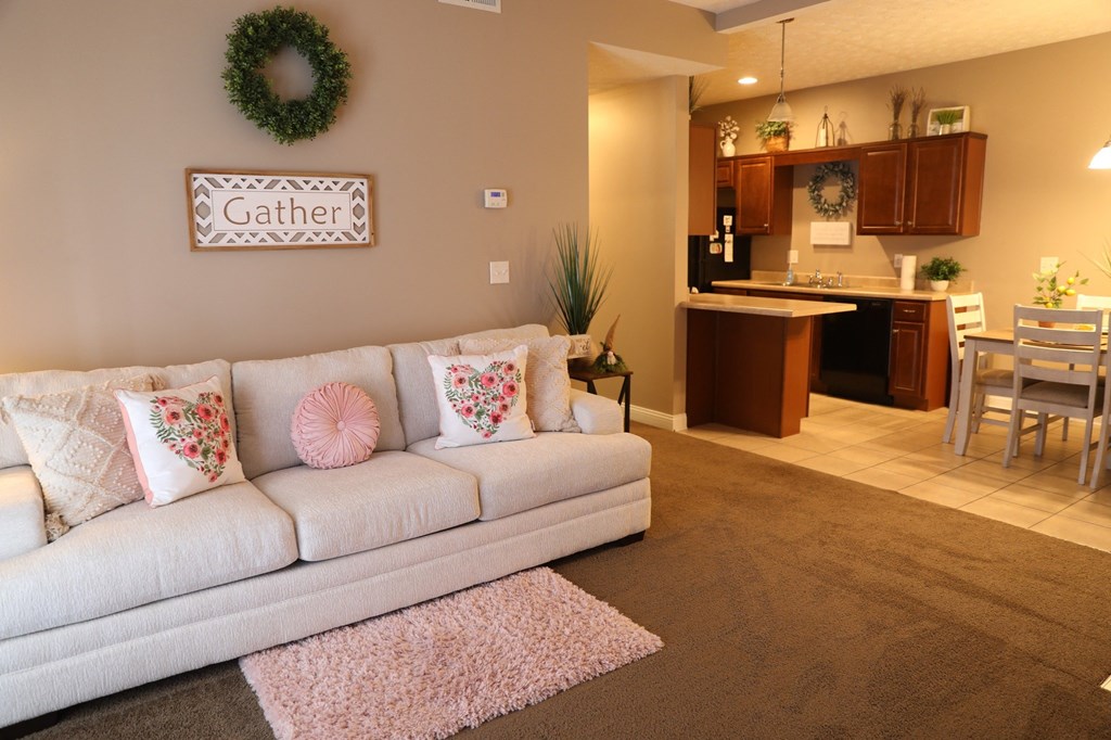 a living room with a couch and a kitchen