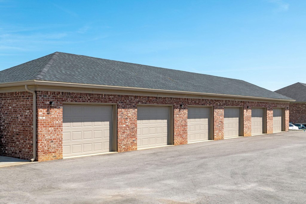 a brick building with a row of garage doors