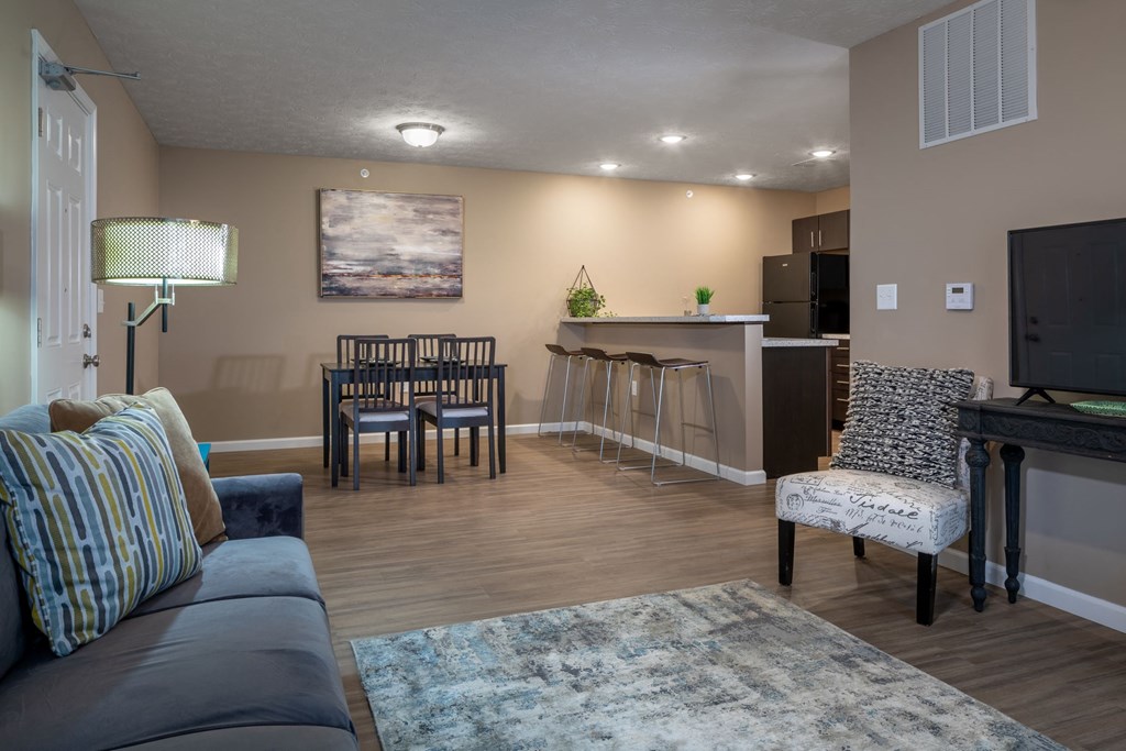 a living room and kitchen with a couch and a table