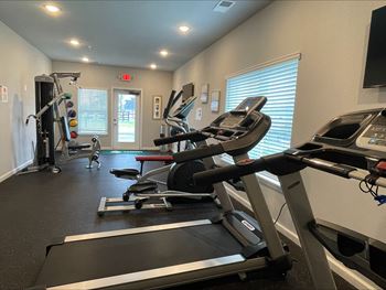 a gym with treadmills and other exercise equipment