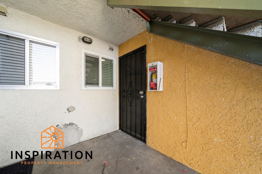 the front door of a building with a boarded up door
