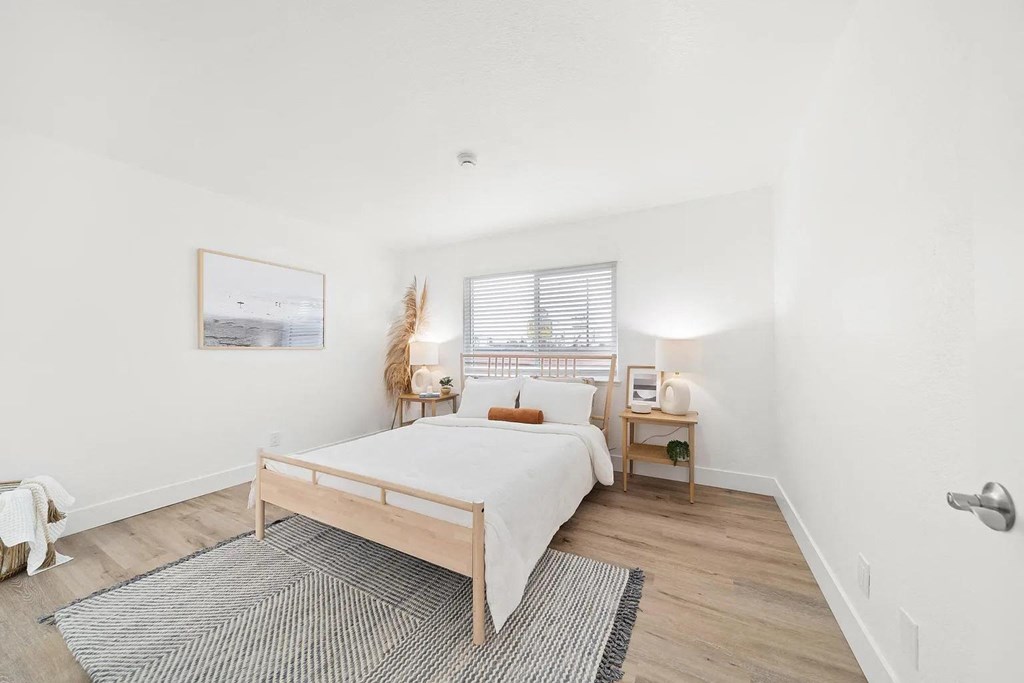 a bedroom with a bed and a rug