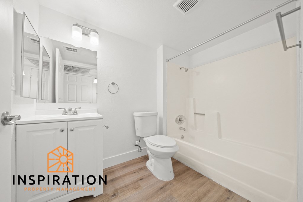 a bathroom with a toilet and a sink and a bath tub