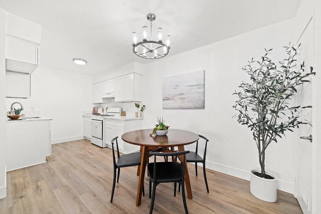 a dining room and kitchen with a table and chairs