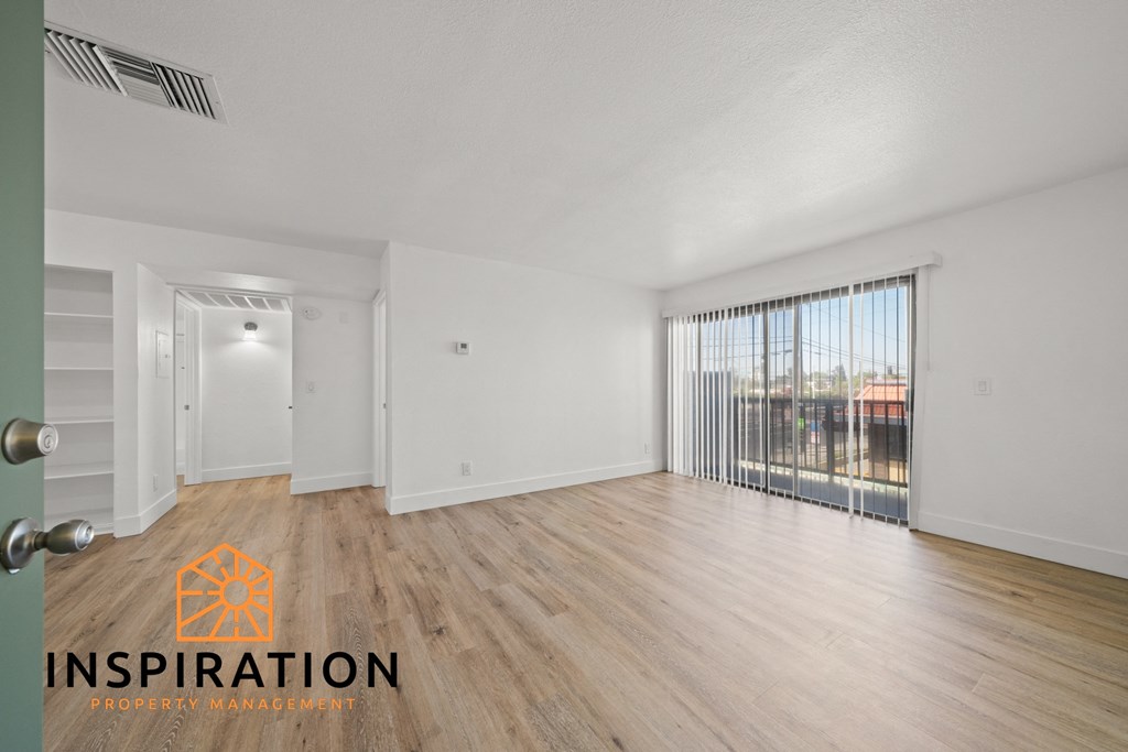 the living room and dining room of an apartment