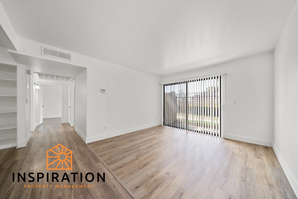 the living room and dining room of an apartment