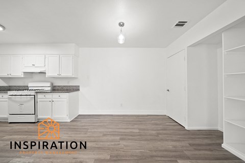 a white kitchen with white cabinets and white appliances