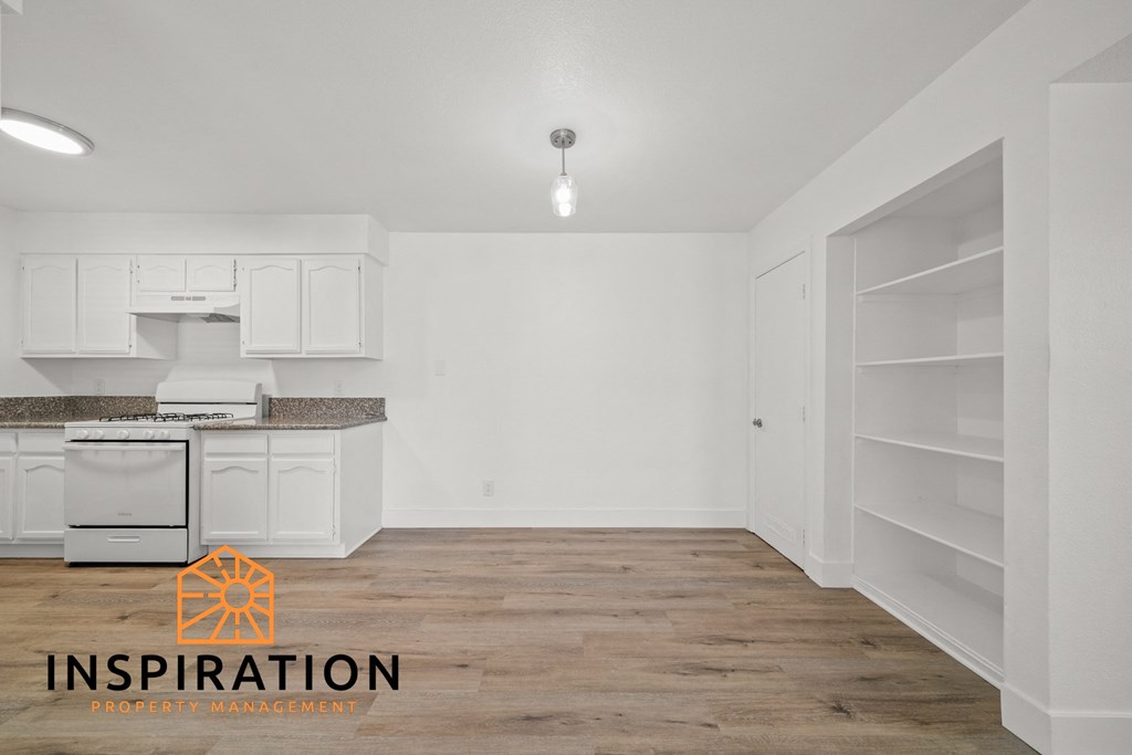 a renovated kitchen with white cabinets and white appliances