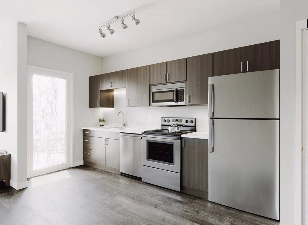 a kitchen with stainless steel appliances and wooden cabinets