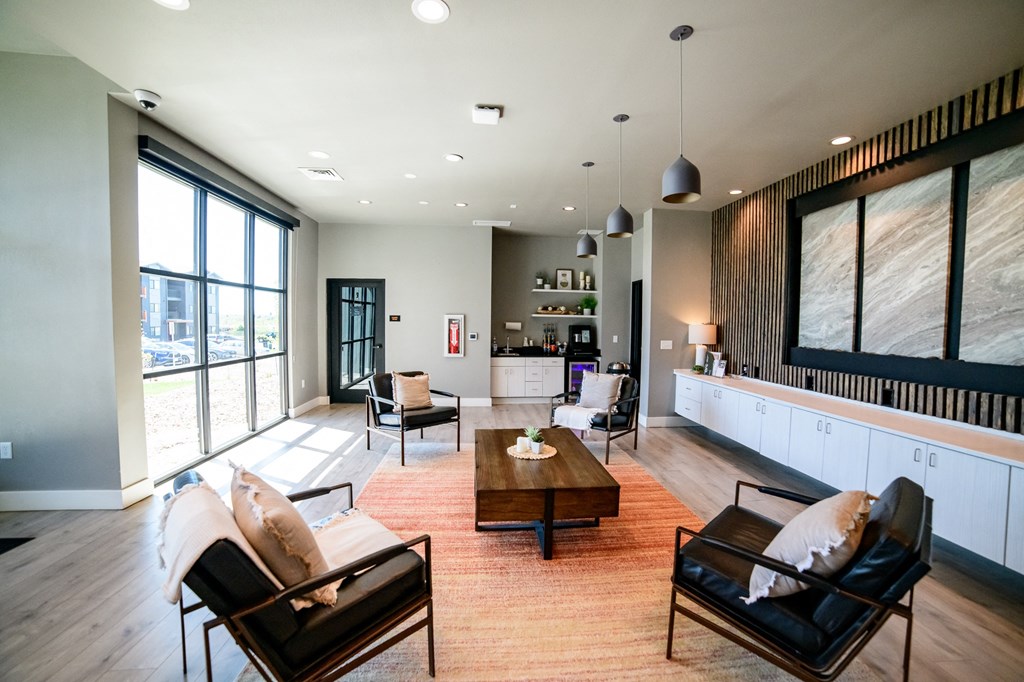 a living room with a couch and chairs and a table