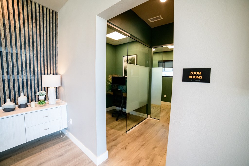 a room with a mirror and a desk in a room room rooms