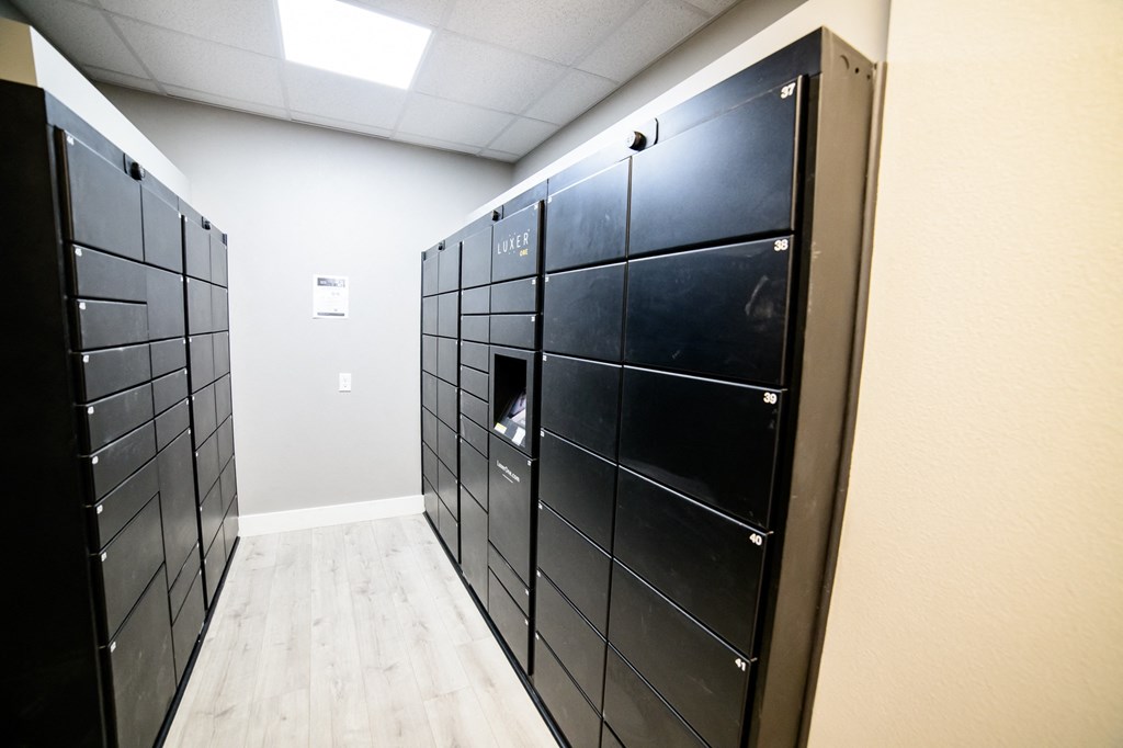 a set of black lockers in a room with a wooden floor