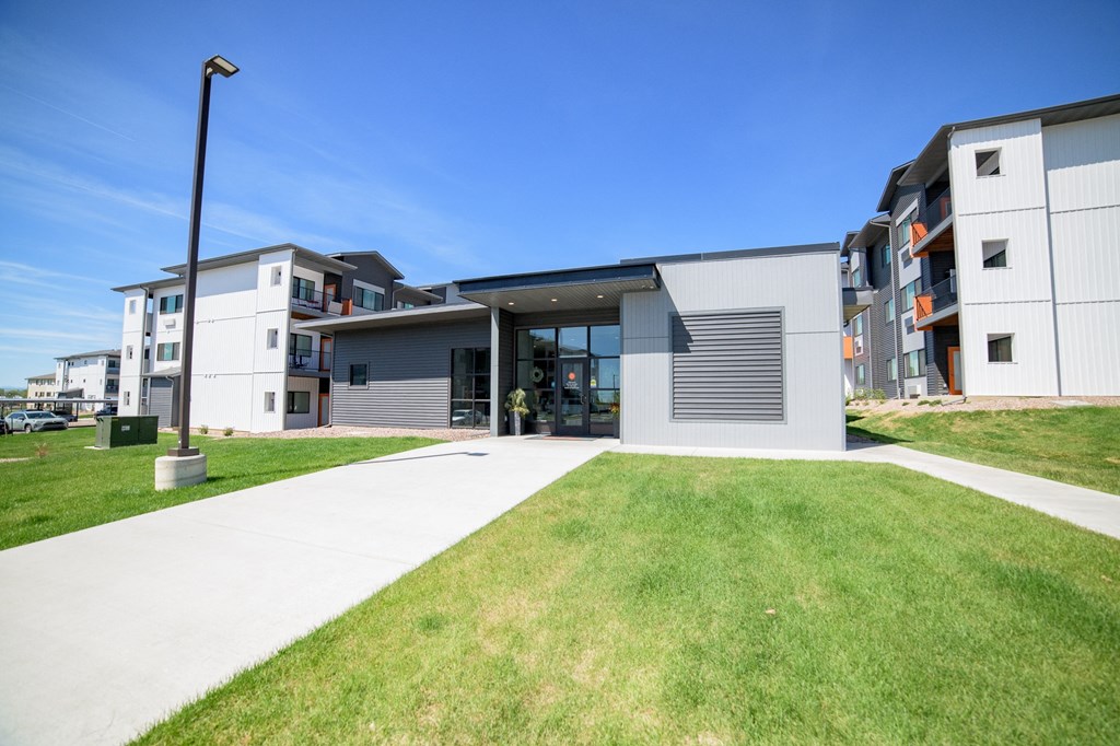 a view of a building with a lawn in front of it