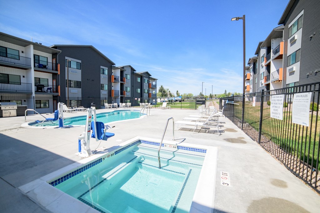 the preserve at ballantyne commons pool and apartment building with pools and chairs