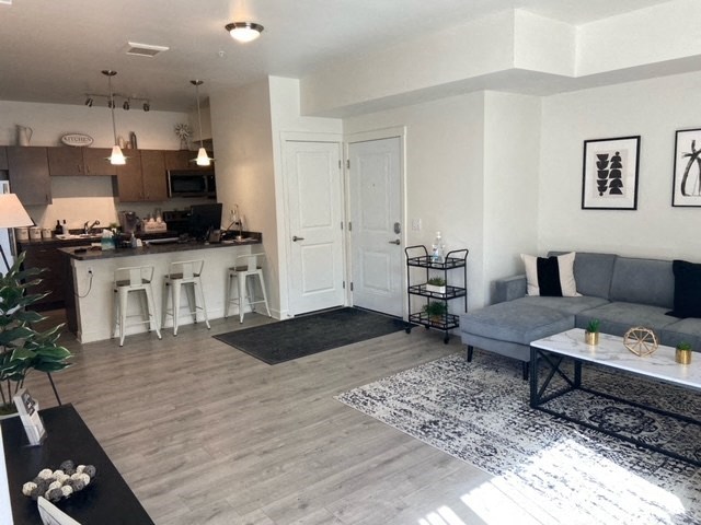 a living room and kitchen with a couch and a table